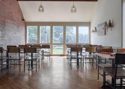 Empty restaurant with large windows.