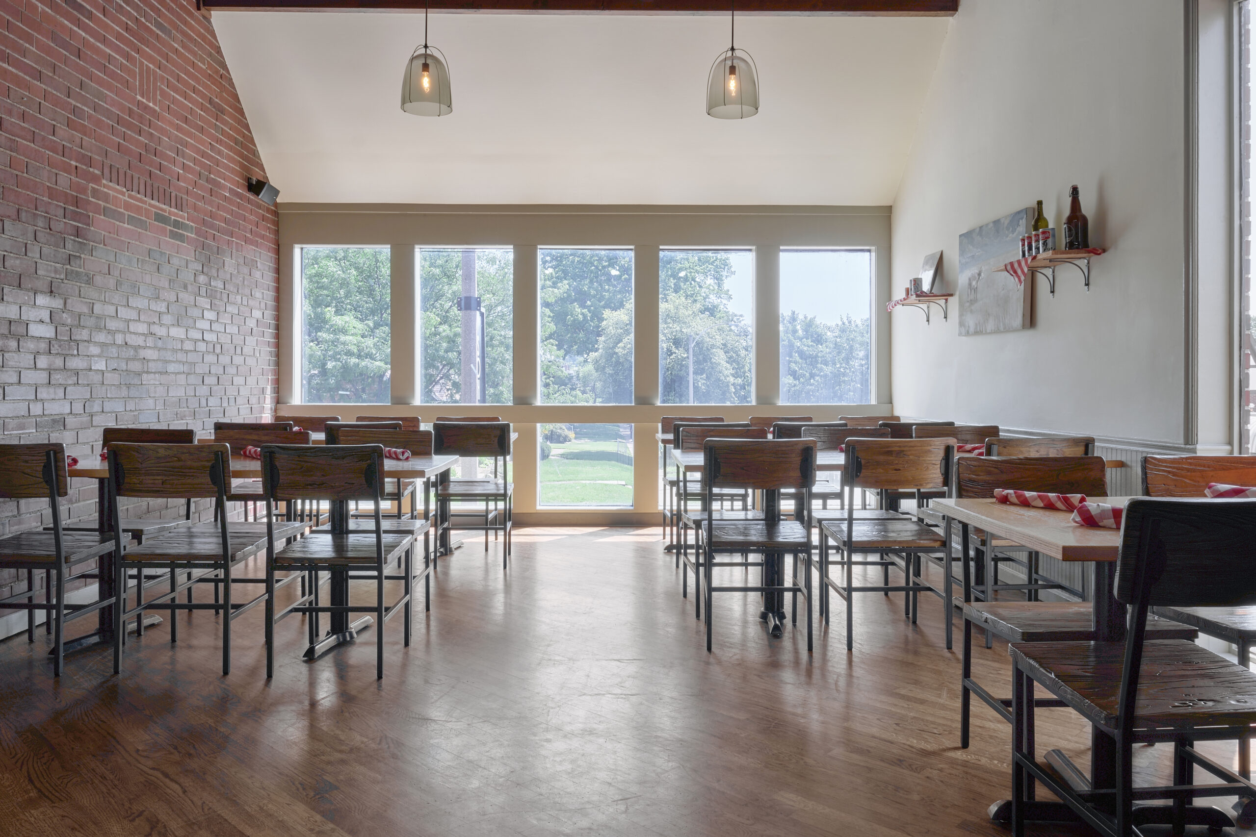 SaltnSmoke-SouthCity-InteriorRoom2-angle6-001 Empty restaurant with large windows.