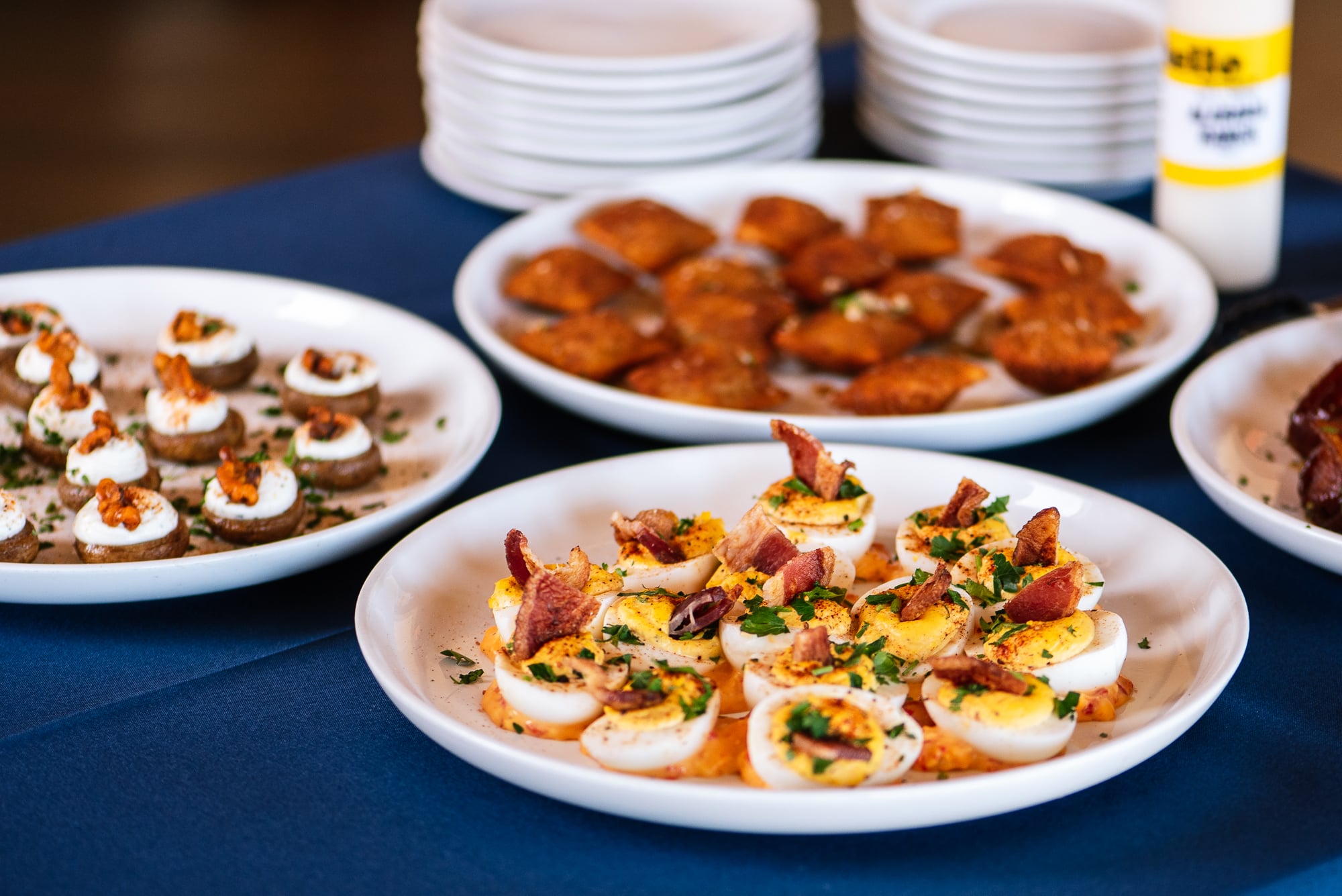 Salt + Smoke BBQ catering appetizers including deviled eggs, mushroom caps, and toasted ravioli
