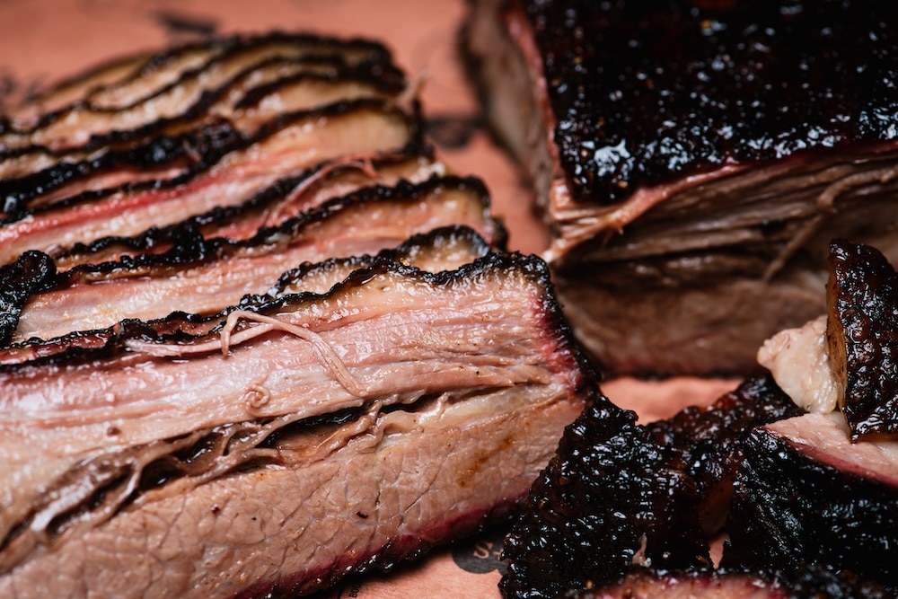 The Ultimate Guide to St. Louis BBQ 4 Sliced smoked brisket best brisket in st. louis on parchment