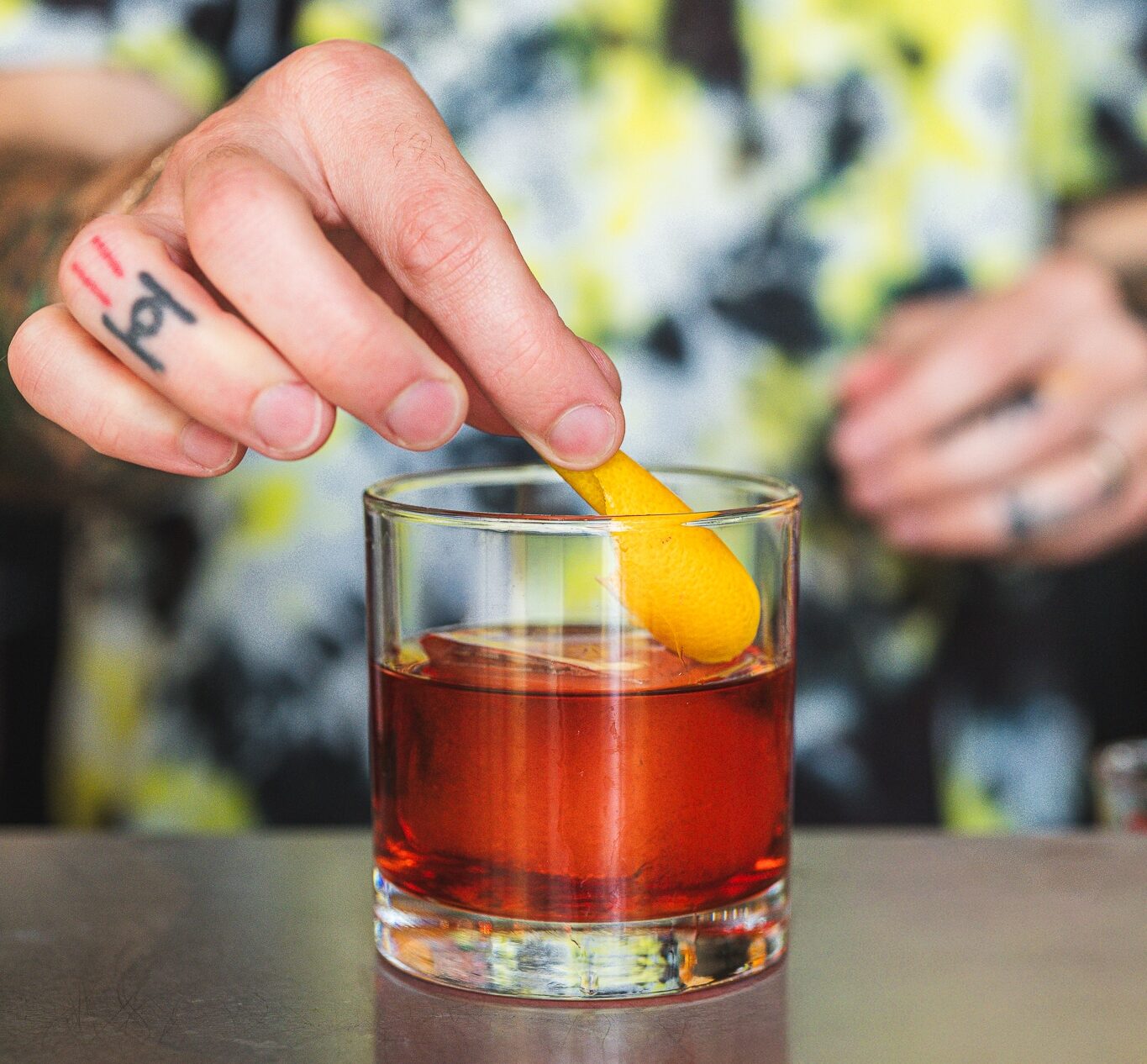 Where to Get the Best Classic Cocktails in St. Louis 1 Hand garnishing cocktail with orange peel