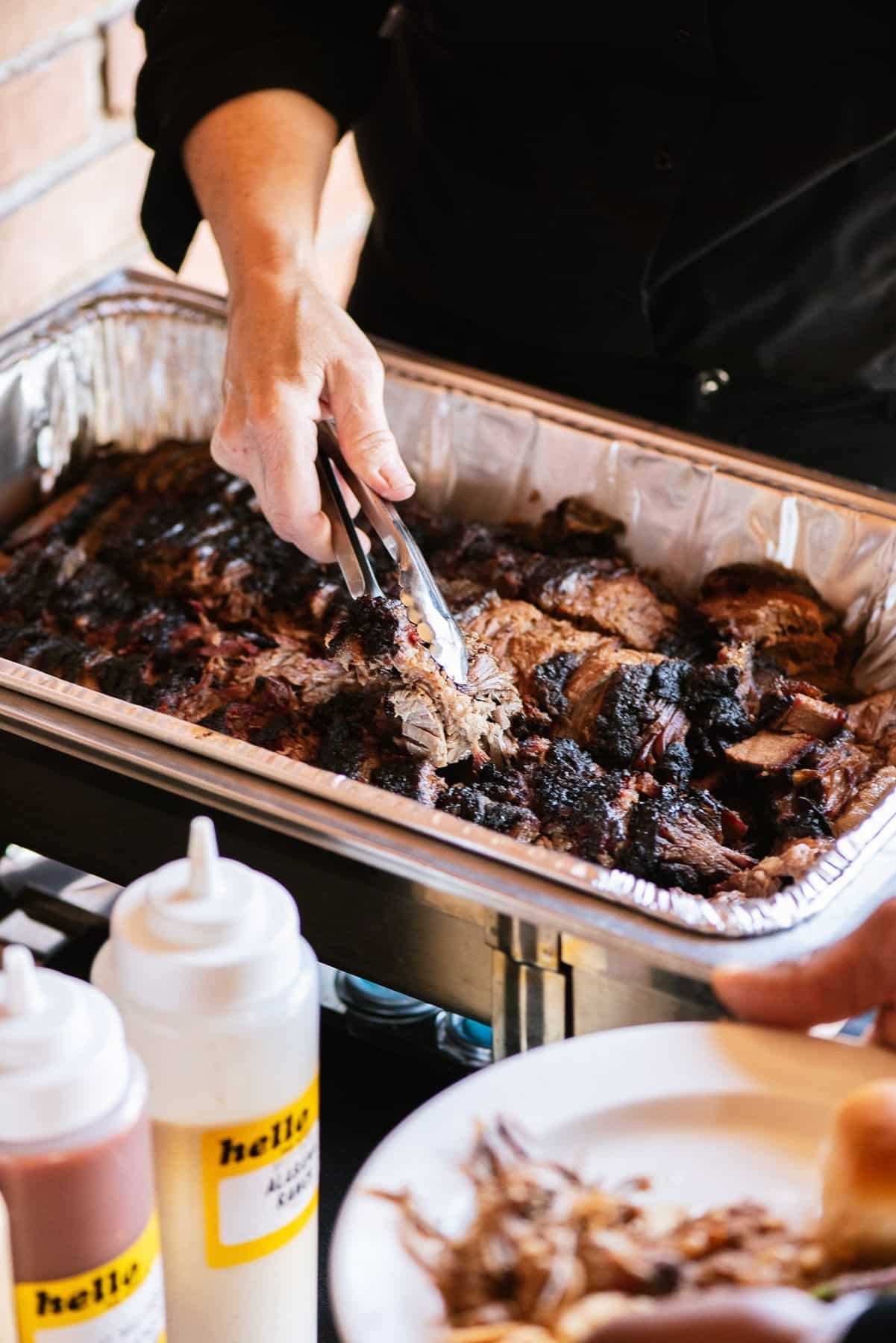 Corporate Catering 3 Smoked brisket being served from a chafing dish