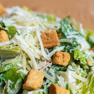 Caesar salad with croutons and shaved cheese
