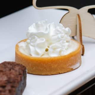 A key lime tart topped with whipped cream