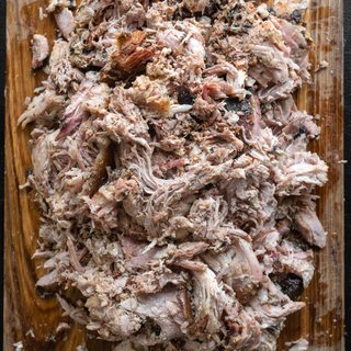 Smoked pulled pork piled on a cutting board