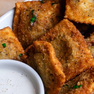 Golden fried toasted ravioli with a creamy dipping sauce