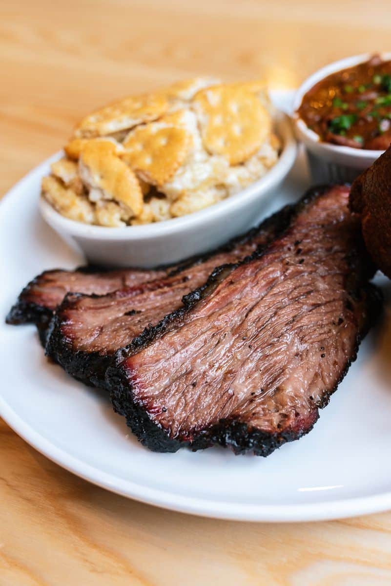 Home 14 Sliced oak-smoked brisket with mac and cheese and BBQ sauce