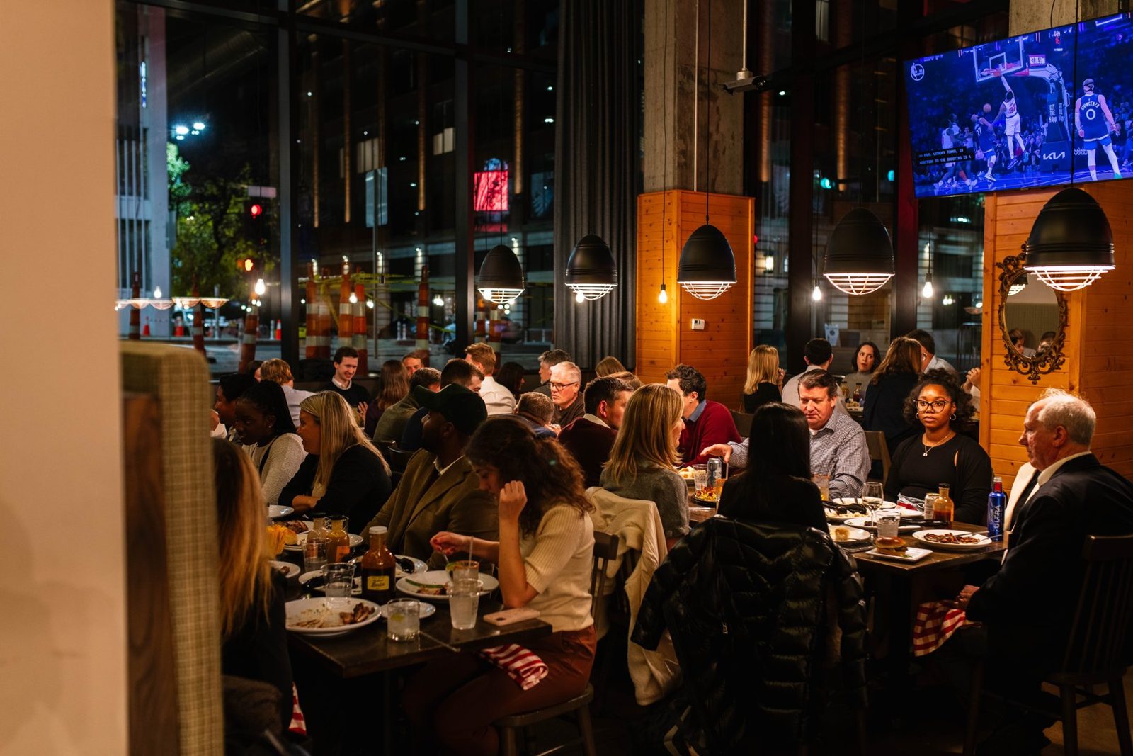 A packed Salt + Smoke dining room at night, with guests at every table