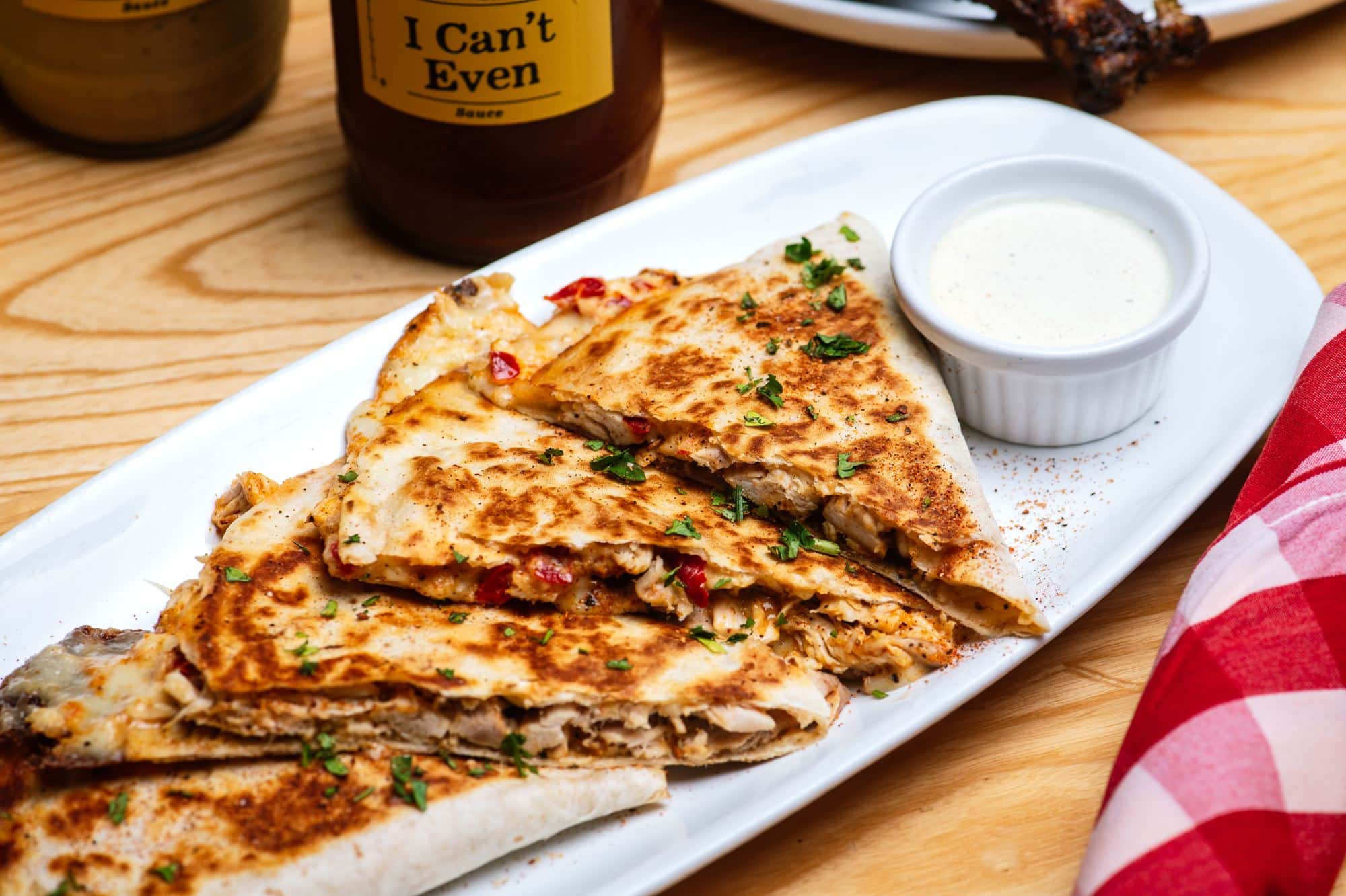 Edwardsville 9 The Birria BBQ Quesadilla, cut and stacked, with dipping sauce